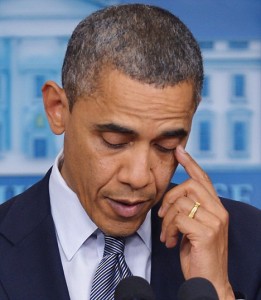 US President Barack Obama wipes his eye
